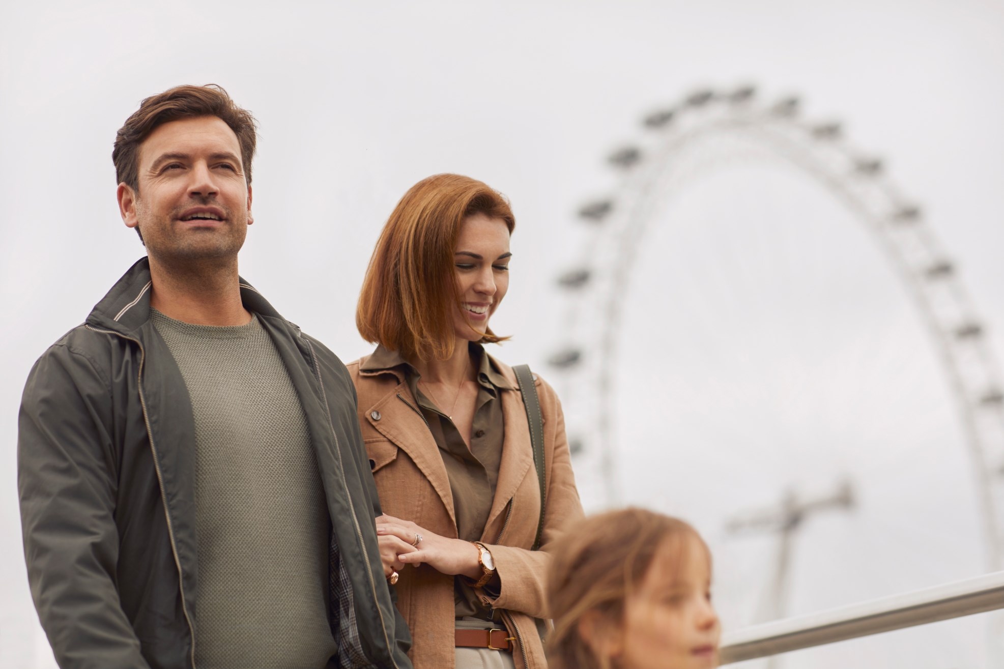 Parents and daughter with London Eye in the background