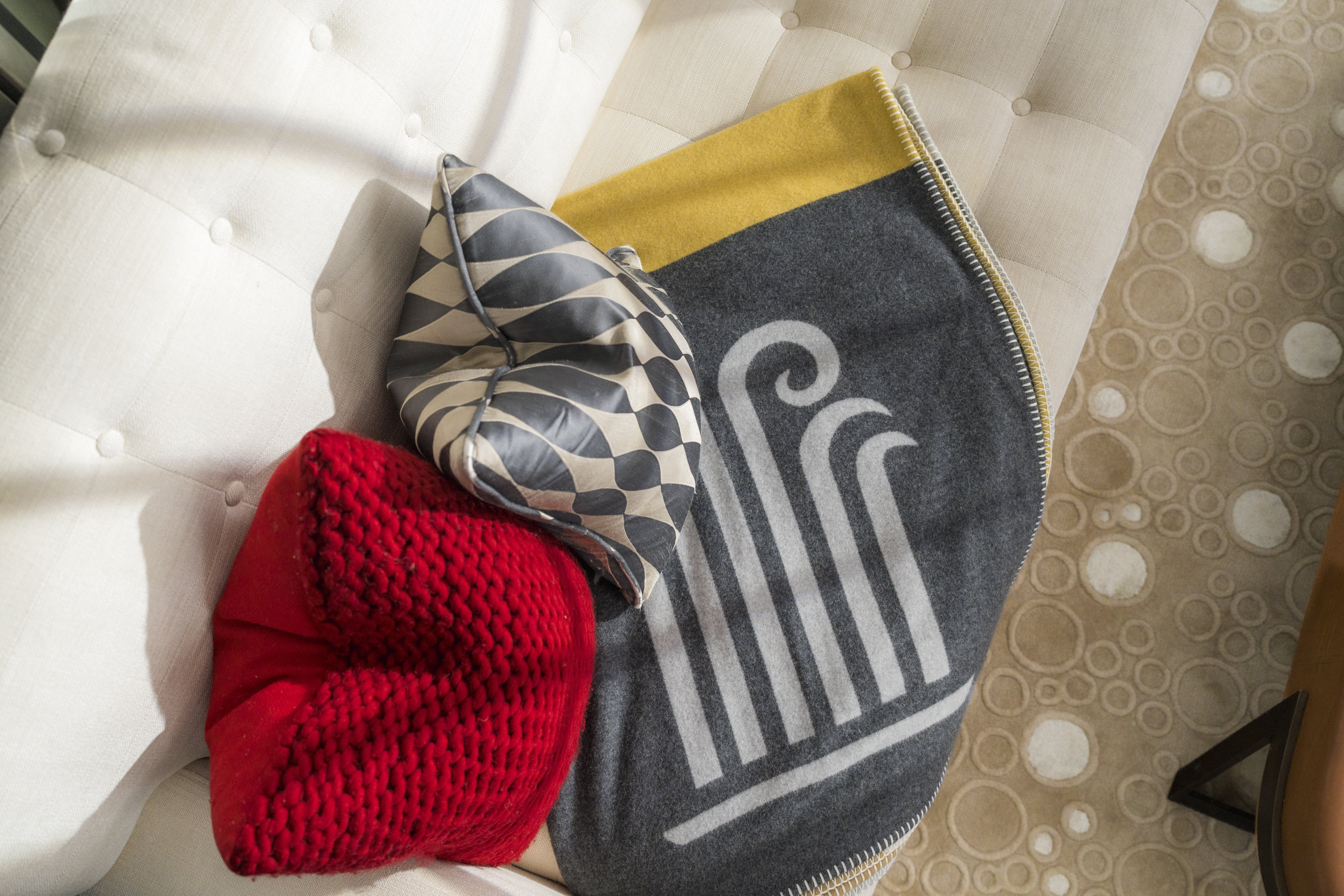 Begg x Co and Corinthia London blanket on the sofa in a London Suite